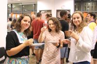 Participants enjoying food, drinks and laughter at the Dutch Cultural Night